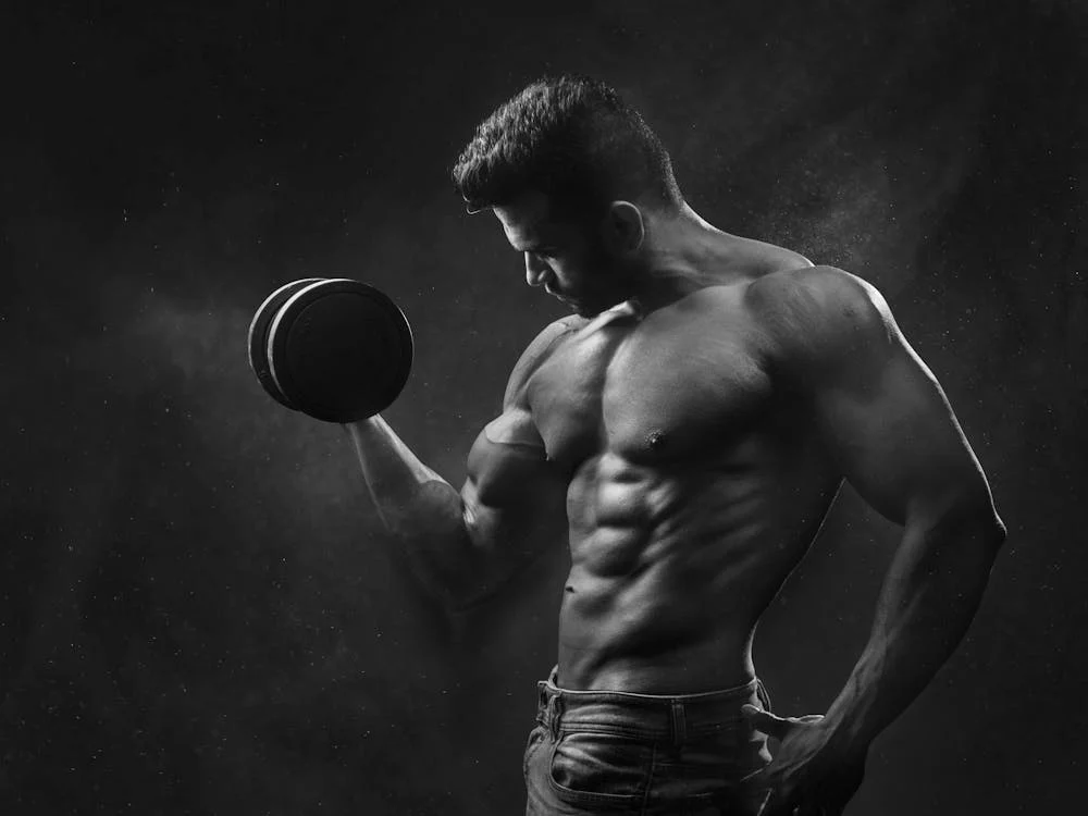 A bodybuilder holding a dumbbell